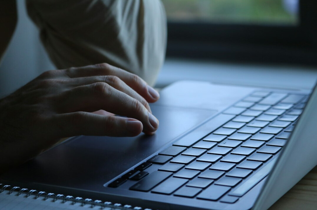mystery writer typing on laptop
